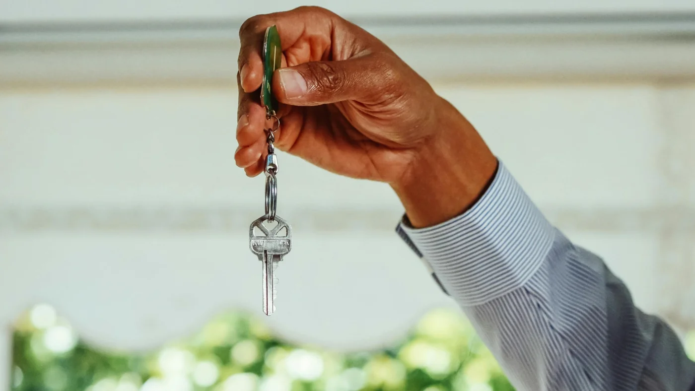 Hand holding a key for business or home